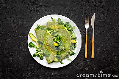 Healthy vegetable pancake. Spinach pancakes on black background top view copy space Stock Photo