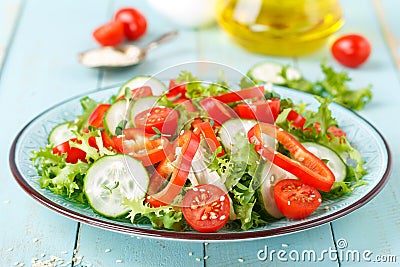 Healthy vegetarian vegetable salad of fresh lettuce, cucumber, sweet pepper and tomatoes. Vegan plant-based food Stock Photo