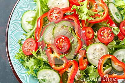 Healthy vegetarian vegetable salad of fresh lettuce, cucumber, sweet pepper and tomatoes. Vegan plant-based food. Flat Lay Stock Photo