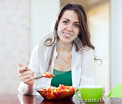 Healthy woman eating veggie salad with spoon Stock Photo