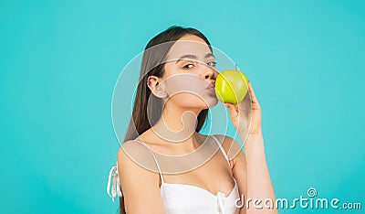 Healthy woman with green apple. Blowing kiss. Beautiful young woman eating an apple. Healthy lifestyle. Happy woman kiss Stock Photo