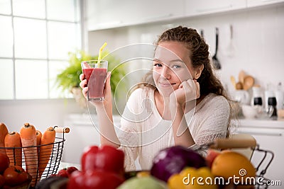 Healthy woman in a kitchen with fruits and vegetables and juice Stock Photo