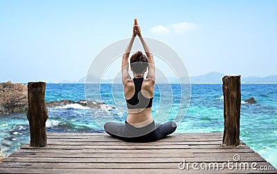 Healthy woman lifestyle exercising vital meditate and practicing yoga at seashore, nature background Stock Photo