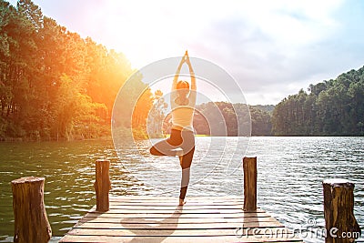 Healthy woman practicing yoga on the bridge Stock Photo