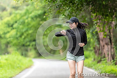 Healthy woman relax after cool down and looking smart watch for check timing run. Stock Photo