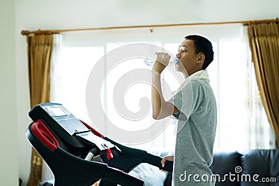 Healthy young asia man drinking water after finish exercise Stock Photo