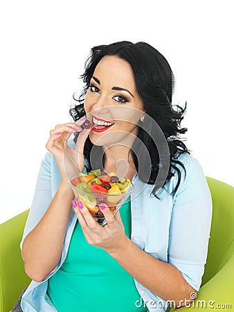 Healthy Young Fresh Faced Woman Holding a Fresh Bowl of Mixed Exotic Fruit Salad Stock Photo