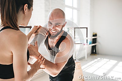 Fit female athlete doing stretching with male trainer Stock Photo