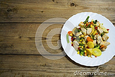 Vegetables and chicken breast on wooden table Stock Photo