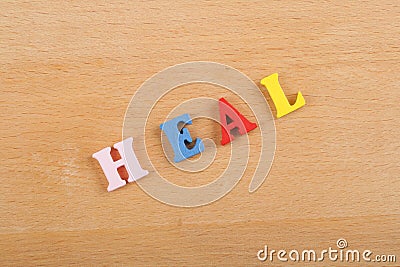 HEALword on wooden background composed from colorful abc alphabet block wooden letters, copy space for ad text. Learning english Stock Photo