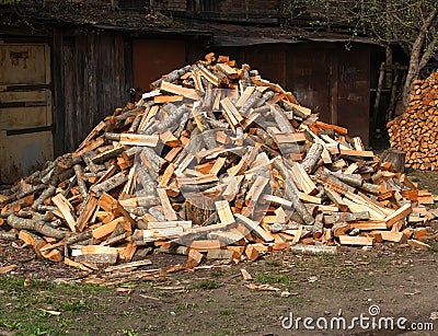 The heap of alder firewood lies in the yard Stock Photo