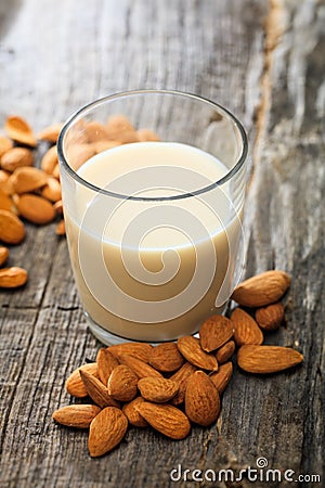 Heap of almonds and a glass of almond milk Stock Photo