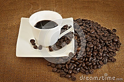 Heap of coffee beans and coffee cup Stock Photo