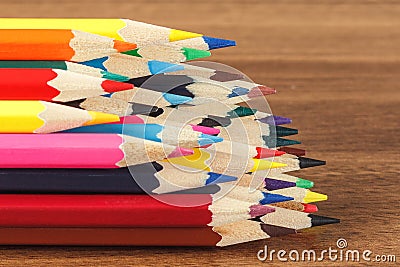 Heap of colored pencils, wooden background Stock Photo