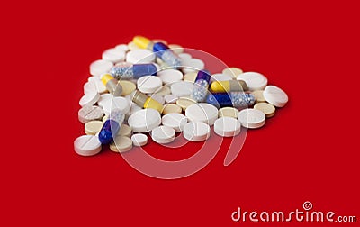Heap of colorful pills in the shape of a heart, tablets and capsules onwhite background. Drug prescription for treatment Stock Photo