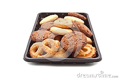 Heap of cookie on black plastic tray, on white Stock Photo