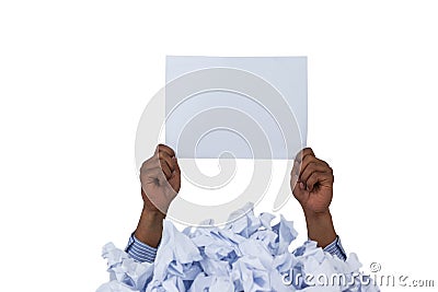 Heap of crumpled paper with hand holding blank page Stock Photo