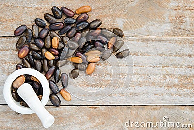 Heap of custard apple seeds or kernels isolated on wood with blank copy text space top view Stock Photo