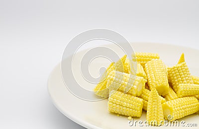 Heap cut baby corn in dish on white background Stock Photo