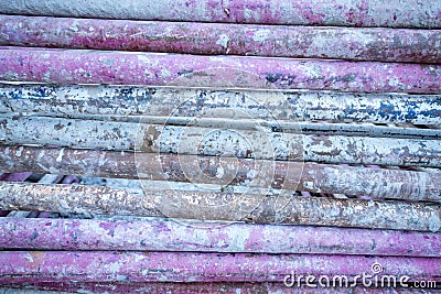 Heap of dirty purple steel pipes Stock Photo