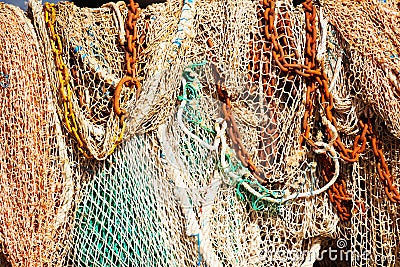 Heap of fishing nets and anchor chains sun-drying Stock Photo