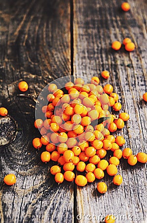 Heap of fresh buckthorn on rustic wooden background Stock Photo