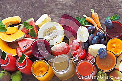 Heap of fresh fruits and fresh prepared cocktails of different colors on a wooden table.Rustic style Stock Photo