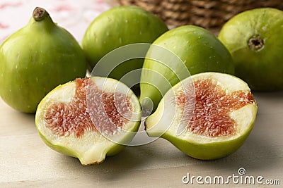 Heap of fresh whole and halved green figs close up Stock Photo