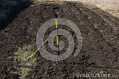 Heap of grass with tool. Cleaning in spring garden Stock Photo