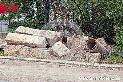 Heap of gray garbage from concrete blocks of stones pipes by the road Stock Photo