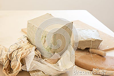 Heap of grey modelling clay. Process of work. Pottery worker working with clay Stock Photo