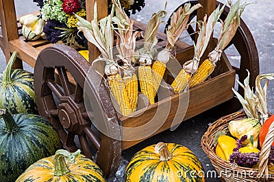 A heap of hay, pumpkin and corn on the cart. Harvest festival decoration Stock Photo