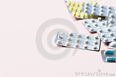 Heap of medical pills in white, blue and other colors. Pills in plastic package. Stock Photo