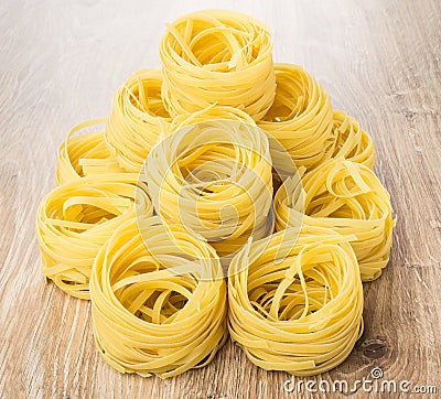 Heap of pasta in form of nest on table Stock Photo