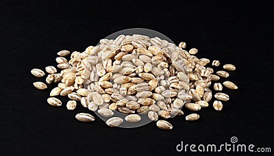 Heap of pearl barley grains on black background Stock Photo