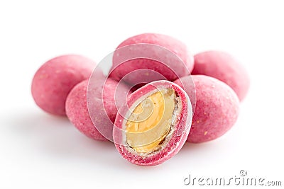 Heap of pink sugared almonds dragees isolated on white background Stock Photo