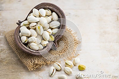 Heap of pistachio on wooden background Stock Photo