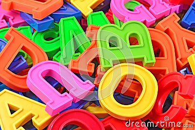 Heap of plastic colored alphabet letters close up Stock Photo