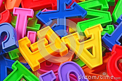 Heap of plastic colored alphabet letters close up Stock Photo