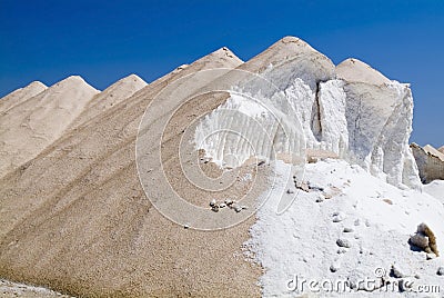 Heap of raw salt against blue sky Stock Photo