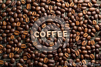 Heap of roasted coffee beans arranged intricately on a matting Stock Photo