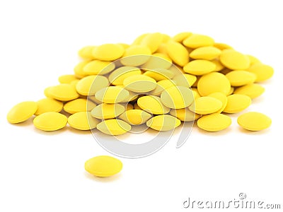 Heap of round yellow pills Stock Photo