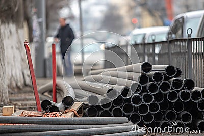 heap of rubber pipes for repair dumped to the ground on a blurred background Stock Photo