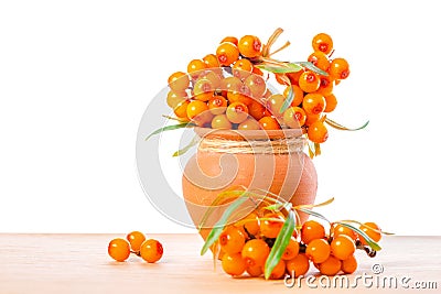 Heap of sea buckthorn berries twigs in vintage ceramic pot is is Stock Photo