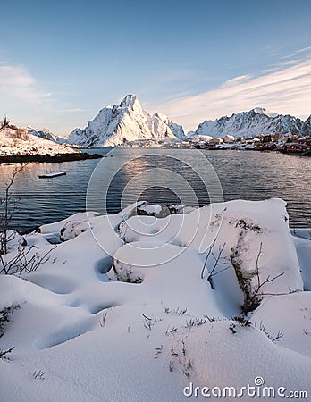 Heap snow with fishing village in snowy mountain at coastline Stock Photo