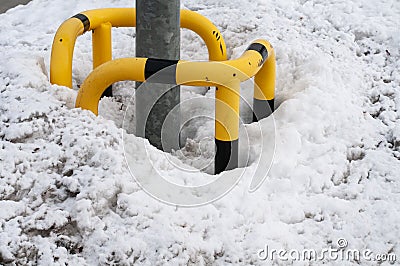 A heap of snow at a post of a street light Stock Photo