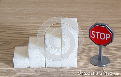 Heap of sugar cubes and stop roadsigns Stock Photo