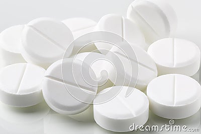 Heap of white round pills and drugs Stock Photo