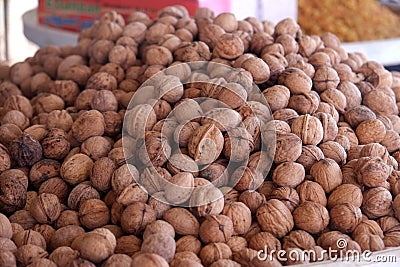 Heap whole walnuts sell in a nuts and dried fruits shop. Stock Photo