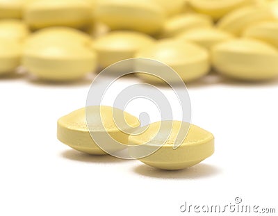 Heap of yellow pills isolated on a white background Stock Photo